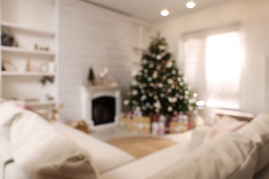 Festive living room interior with beautiful Christmas tree, blurred view