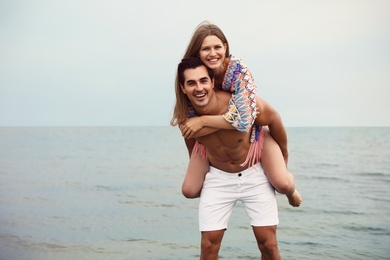 Photo of Happy young couple having fun on sea beach