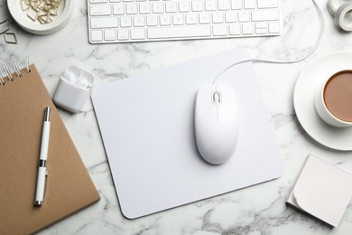 Photo of Modern workplace with mouse and keyboard on marble table, flat lay