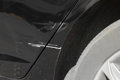 Photo of Modern black car with scratch, closeup view