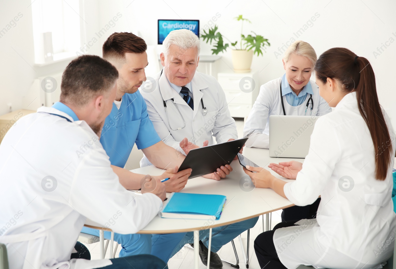 Photo of Group of doctors attending meeting in clinic. Cardiology conference