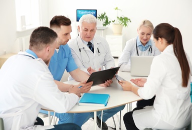 Group of doctors attending meeting in clinic. Cardiology conference