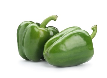 Photo of Ripe green bell peppers on white background