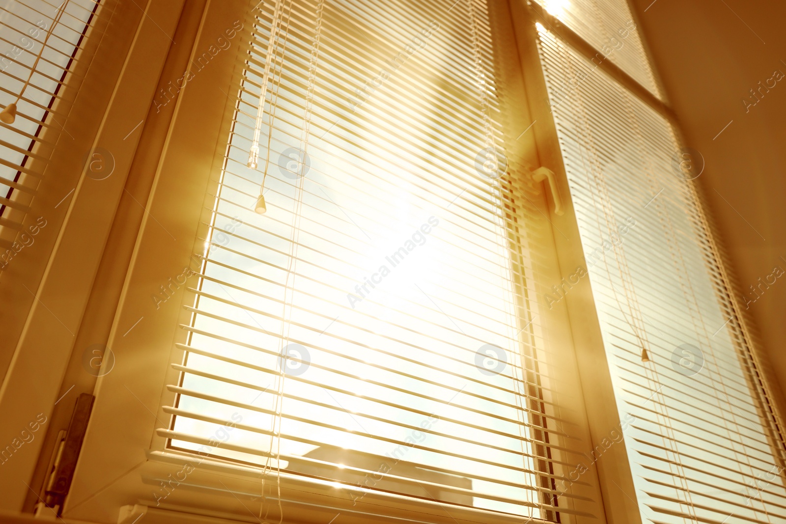 Image of Stylish window with horizontal blinds in room, low angle view