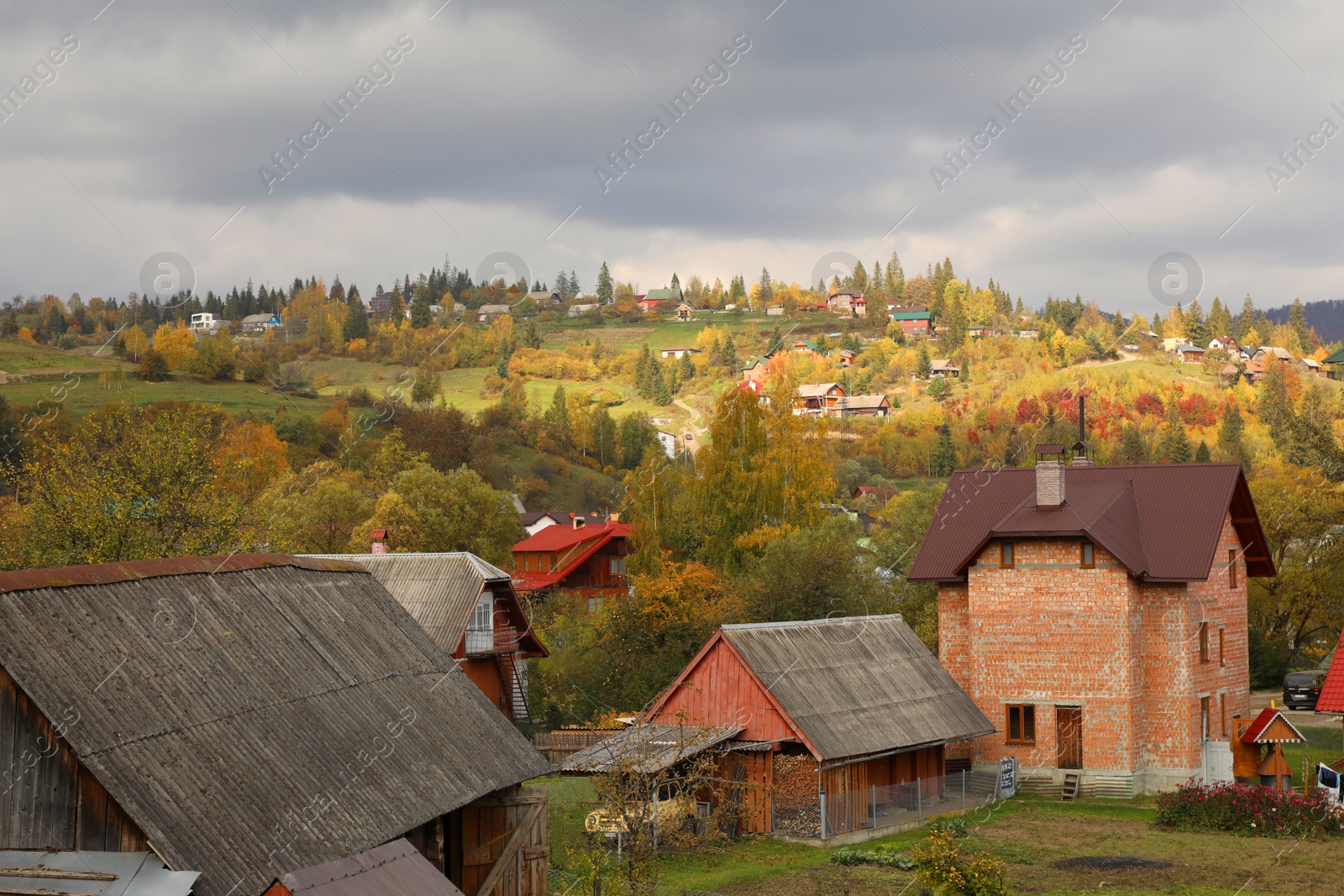 Photo of Beautiful view of forest and mountain village on autumn day