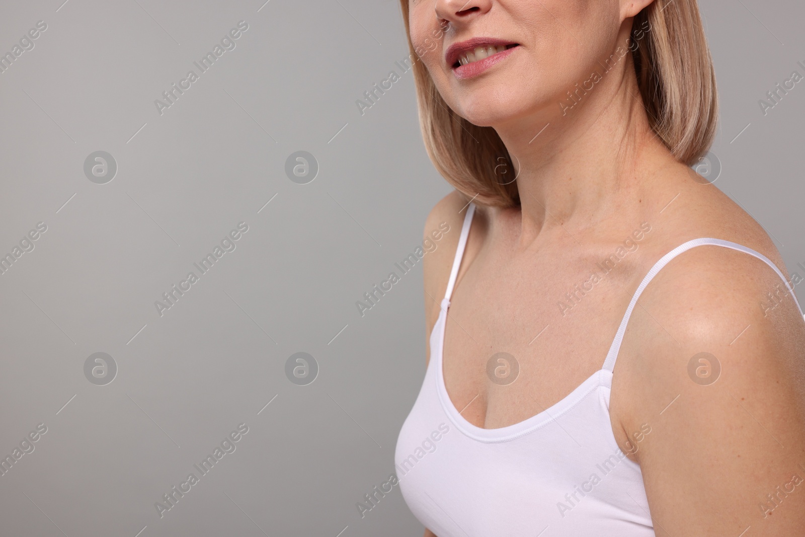 Photo of Woman with healthy skin on grey background, closeup. Space for text