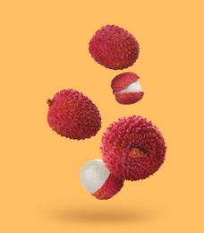 Image of Fresh lychees falling on pale orange background