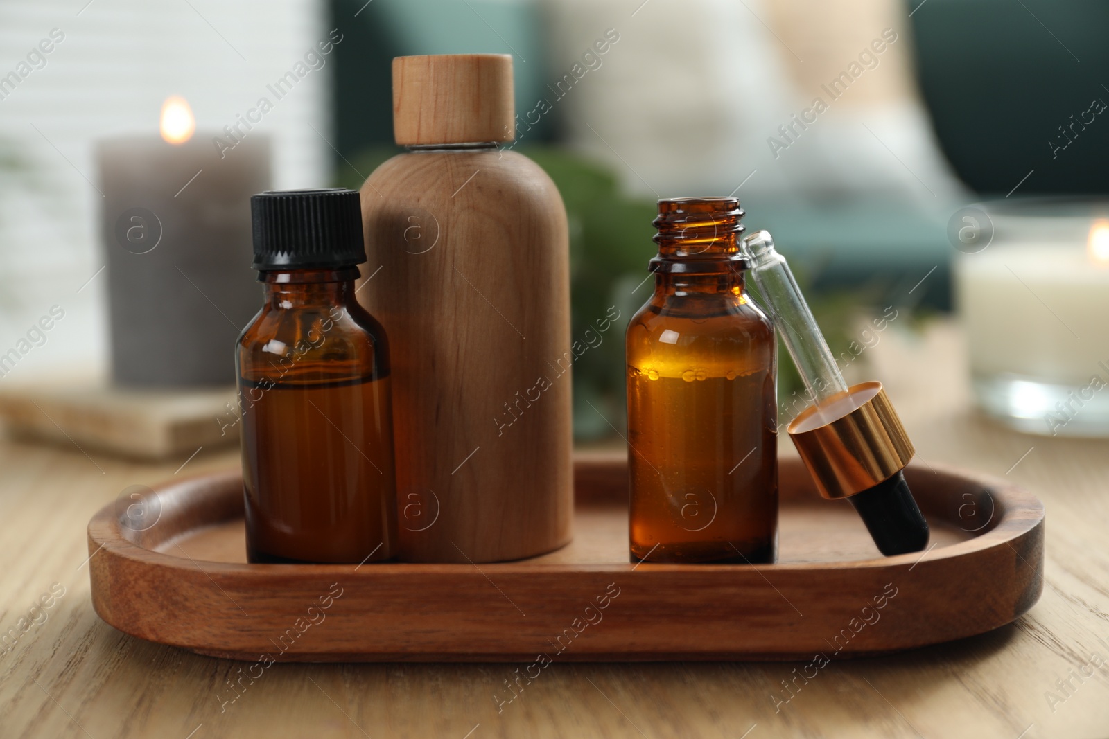 Photo of Aromatherapy. Bottles of essential oil on wooden table