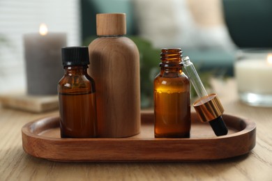Aromatherapy. Bottles of essential oil on wooden table