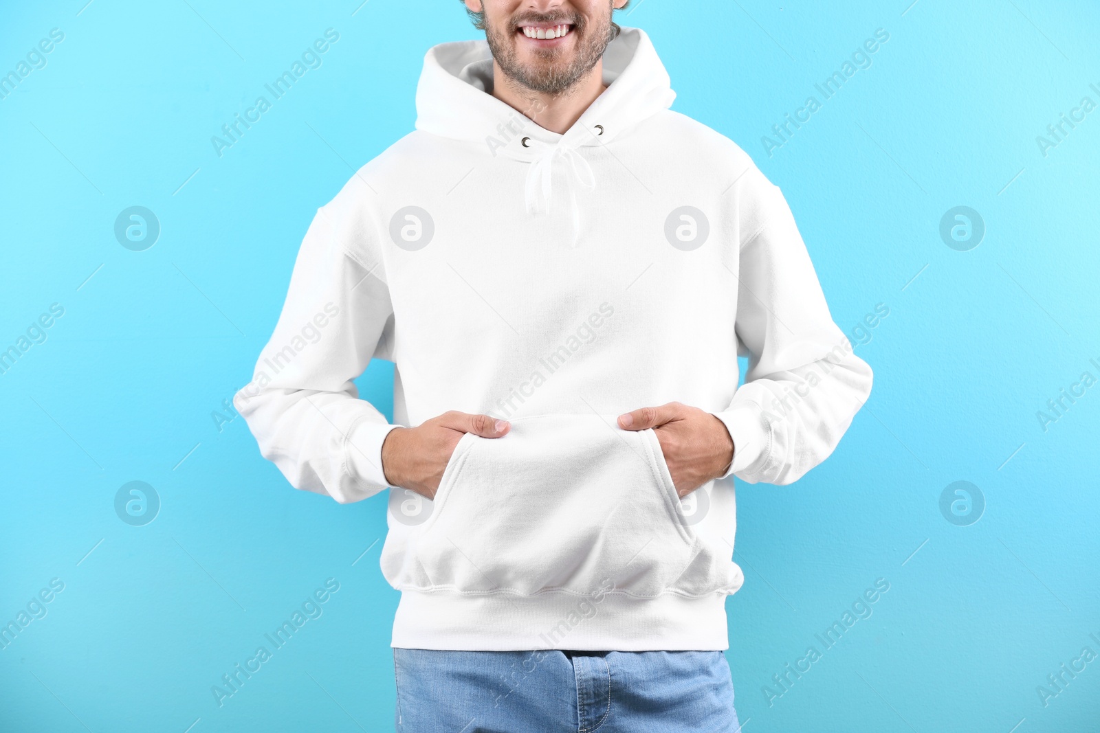 Photo of Man in hoodie sweater on color background. Space for design