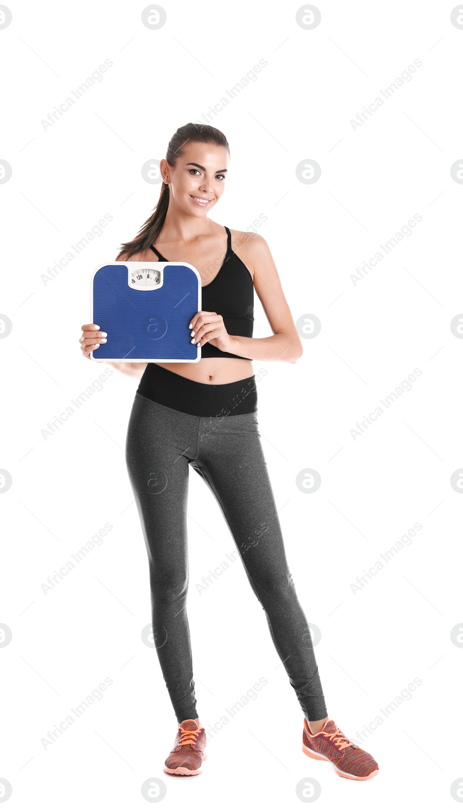 Photo of Happy young woman with scales on white background. Weight loss motivation