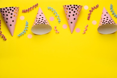 Flat lay composition with party items on yellow background, space for text