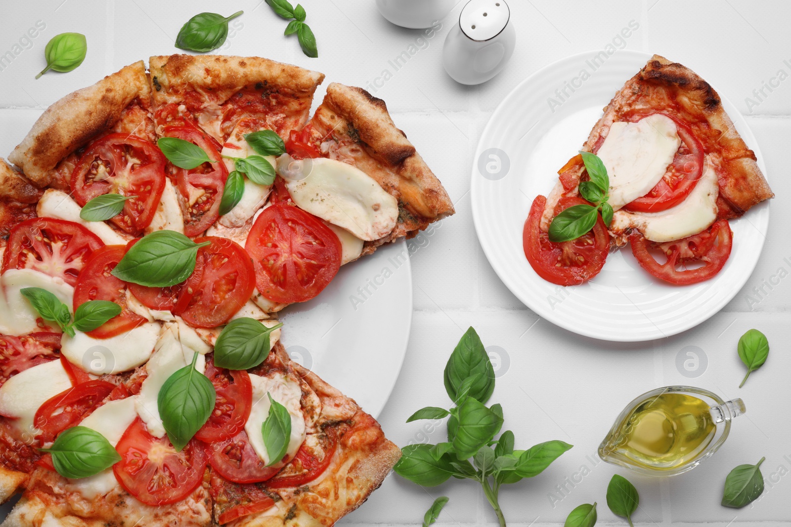 Photo of Delicious Caprese pizza on white tiled table, flat lay