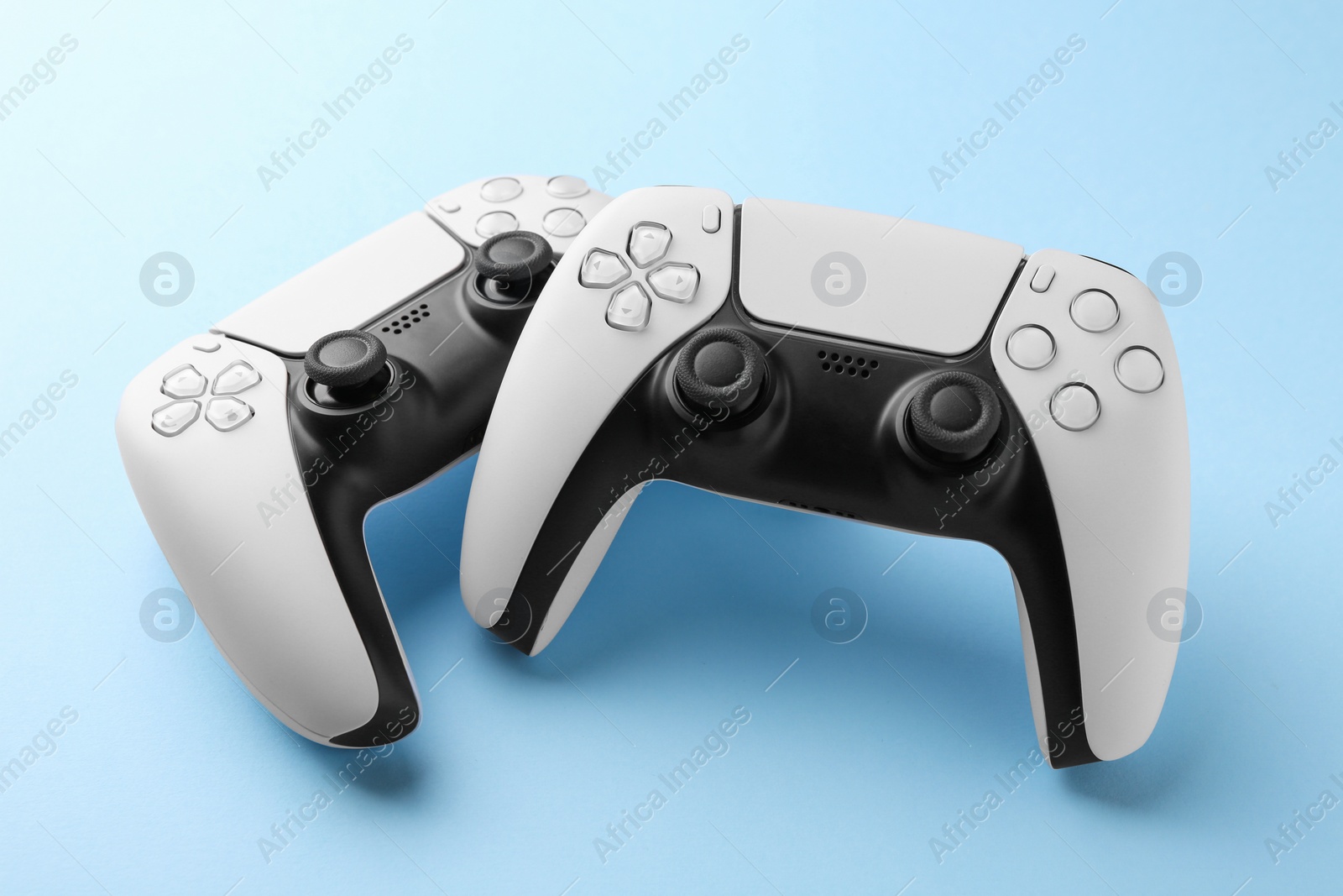 Photo of Wireless game controllers on light blue background