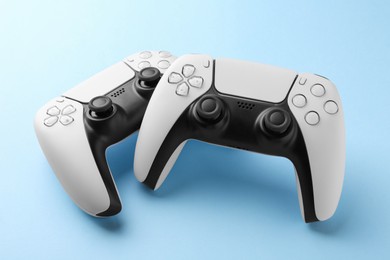 Wireless game controllers on light blue background