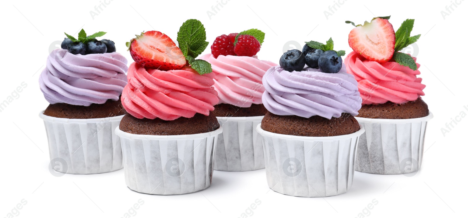 Photo of Sweet cupcakes with fresh berries on white background