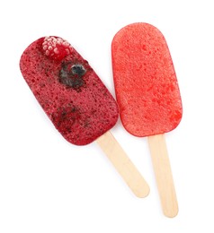 Photo of Tasty berry ice pops isolated on white, top view. Fruit popsicle