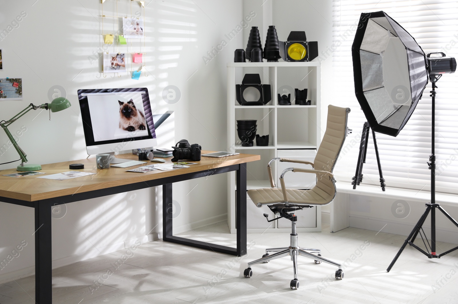 Photo of Photographer's workplace with professional camera and computer in office