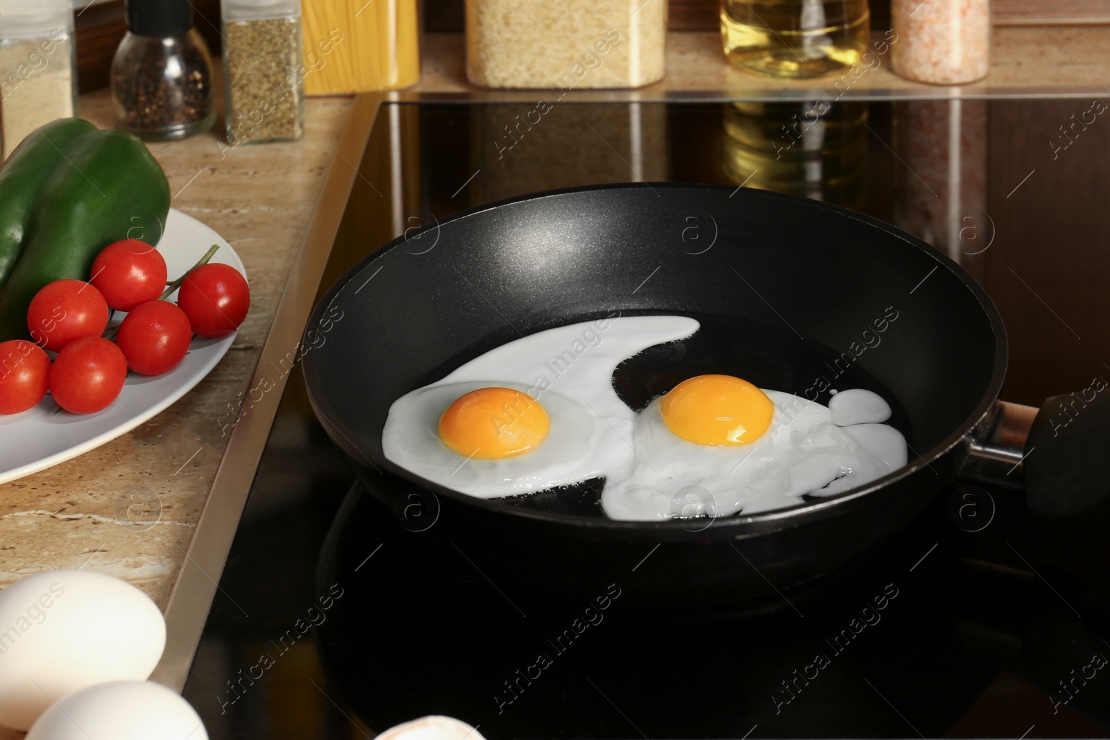 Photo of Cooking eggs for breakfast in frying pan on cooktop