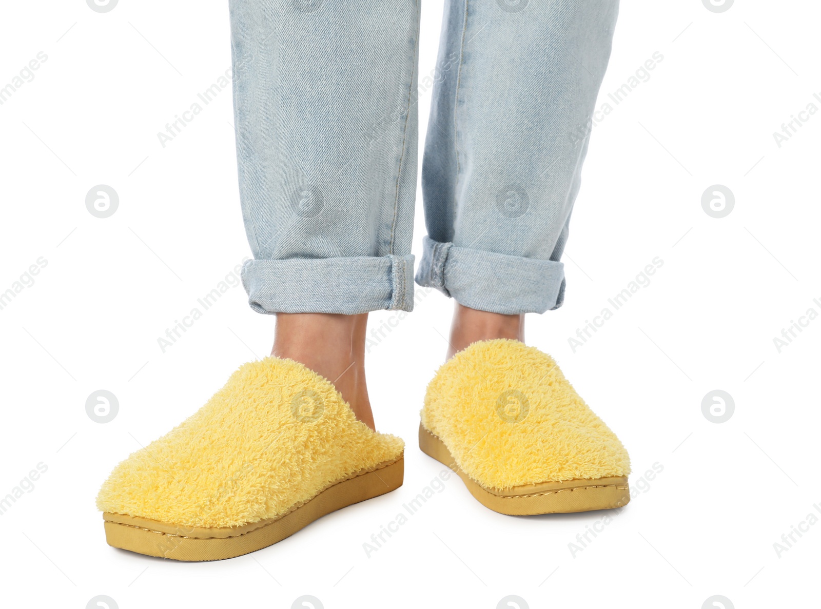 Photo of Woman in yellow soft slippers on white background, closeup