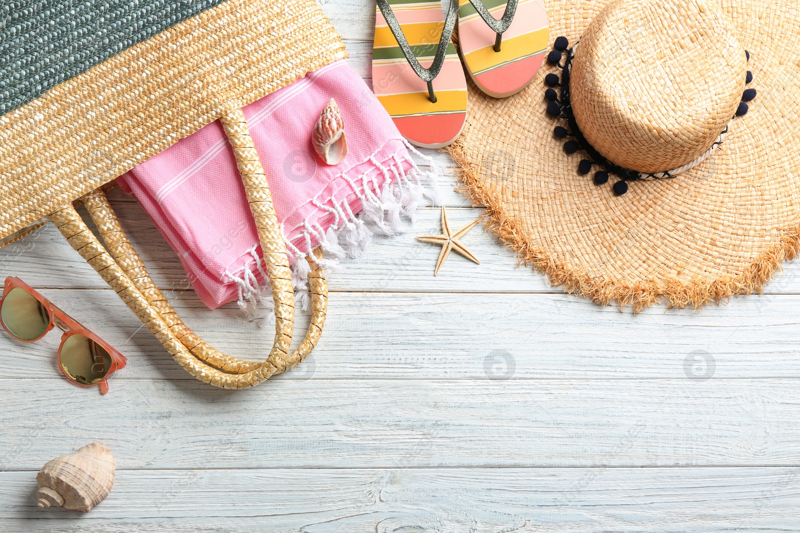 Photo of Flat lay composition with beach accessories on wooden background. Space for text