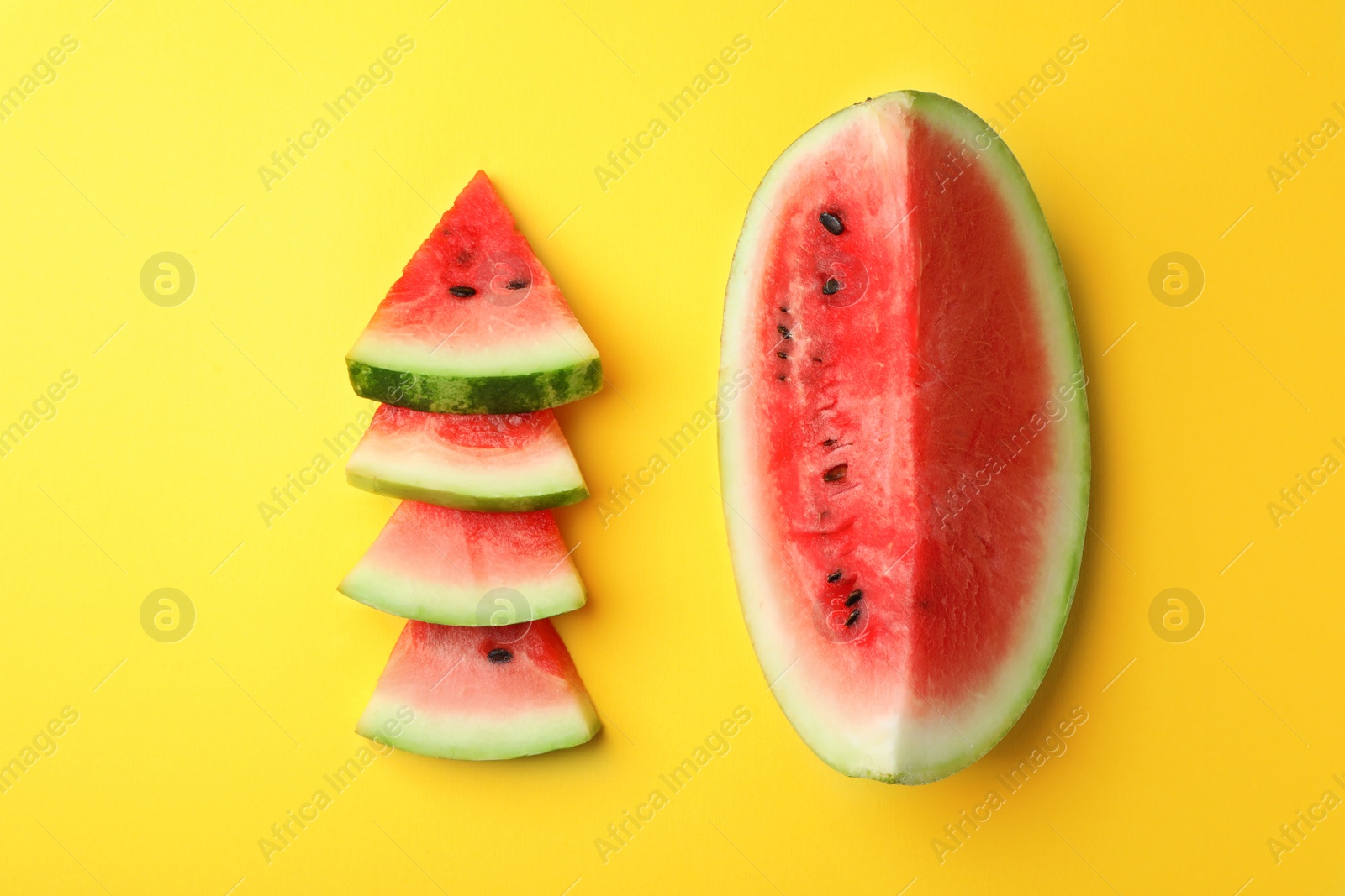 Photo of Flat lay composition with slices of watermelon on color background