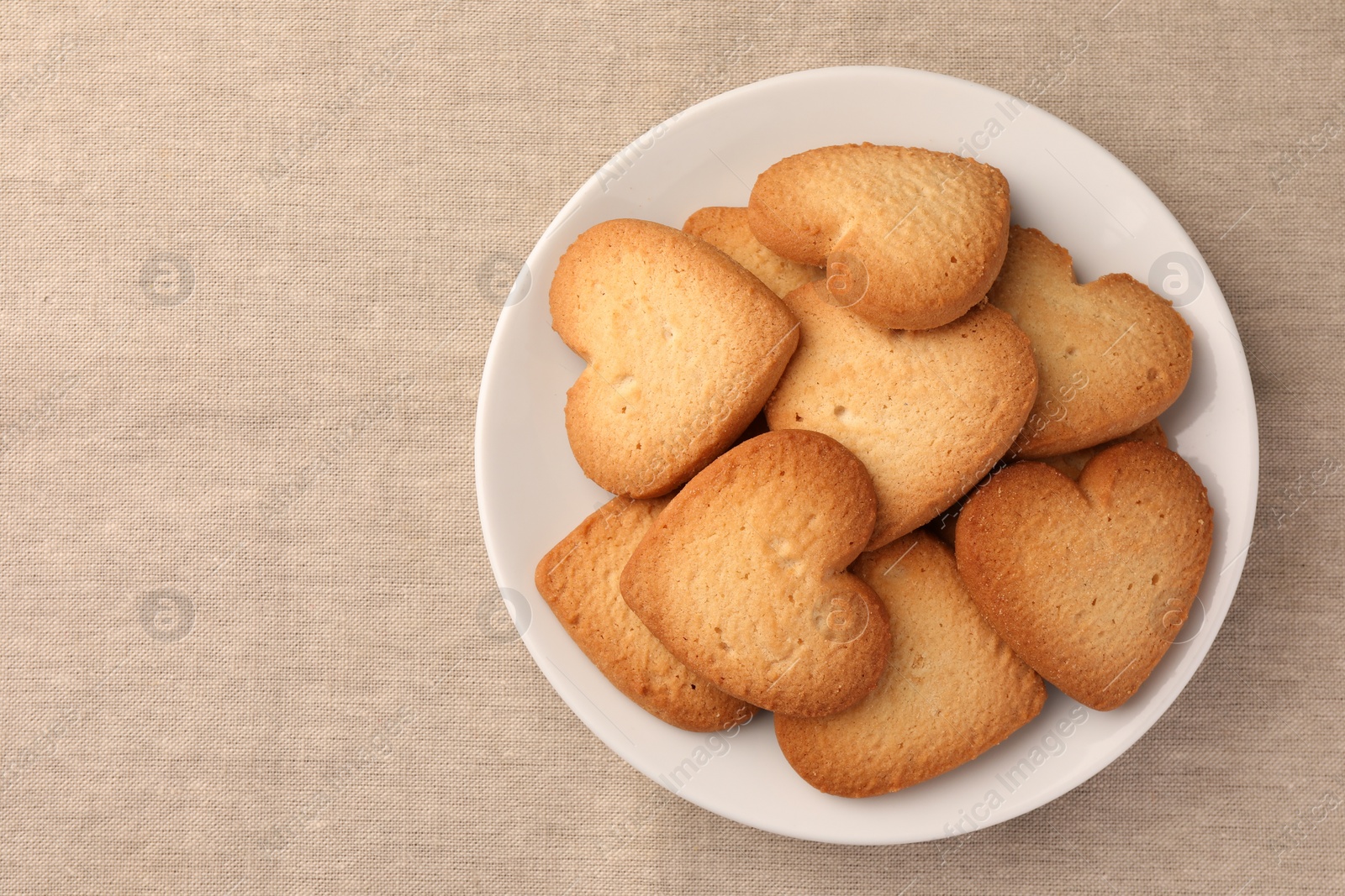 Photo of Heart shaped Danish butter cookies on table, top view. Space for text