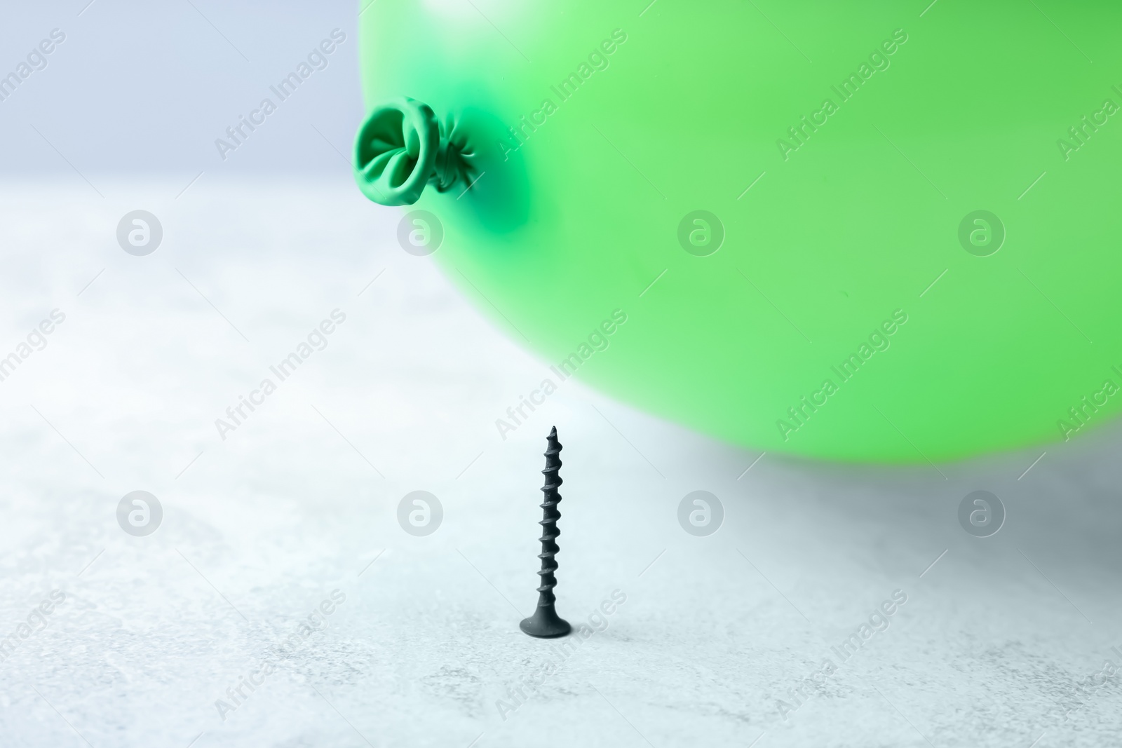 Photo of Color balloon and nail on table against white background, space for text