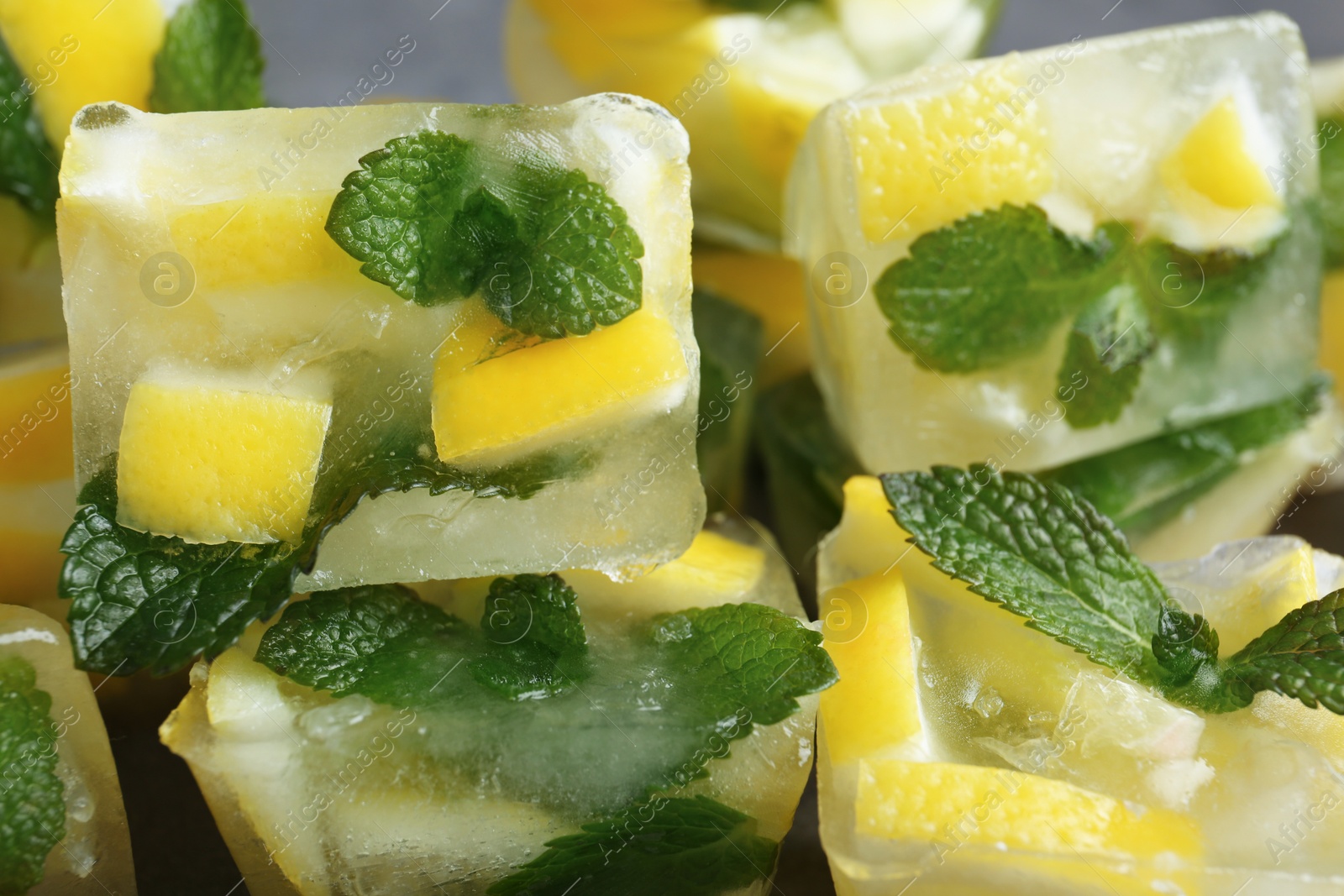 Photo of Ice cubes with mint and lemon, closeup