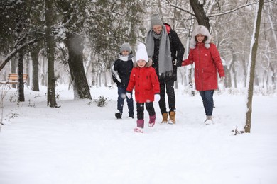 Family spending time outside on winter day. Christmas vacation