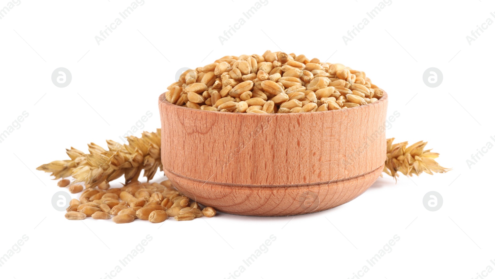 Photo of Wooden bowl with wheat grains and spikes on white background