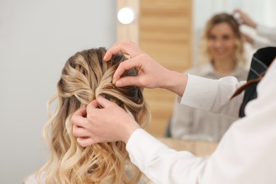 Photo of Hair styling. Professional hairdresser working with client in salon, closeup