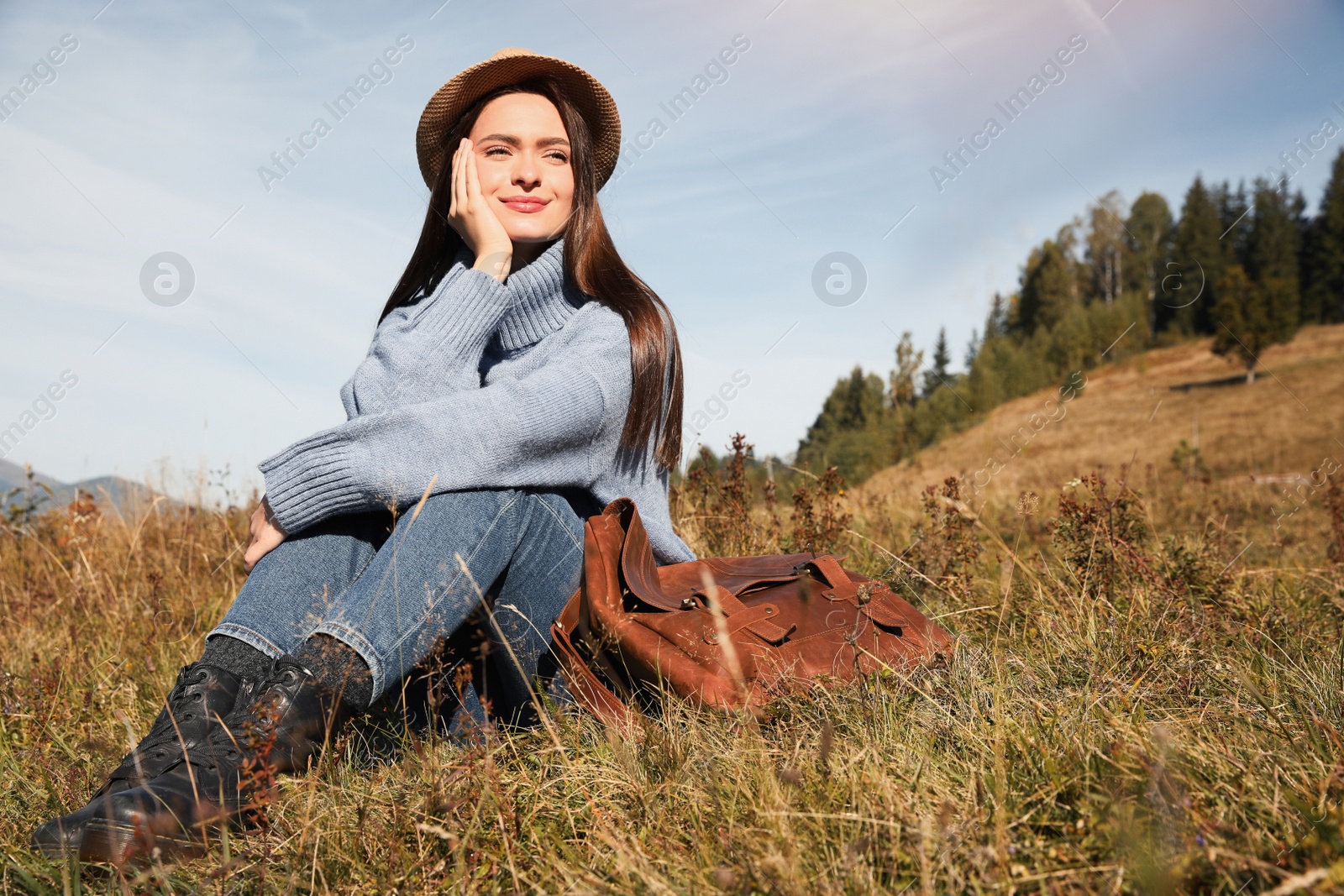 Photo of Young woman enjoying beautiful mountain landscape on sunny day