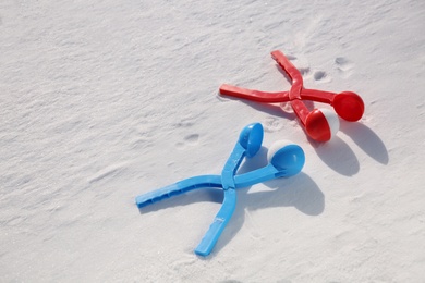 Photo of Snowballs and plastic tools outdoors on winter day