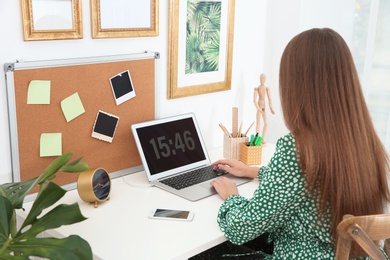 Photo of Woman using computer in home office. Stylish workplace