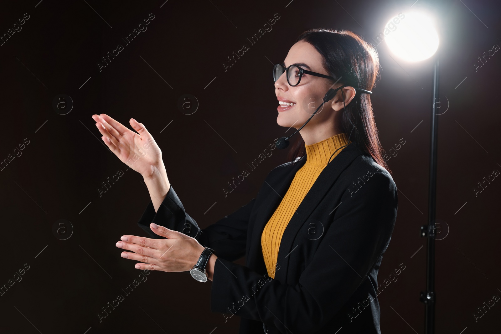 Photo of Motivational speaker with headset performing on stage