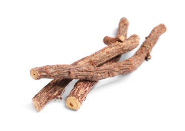 Dried sticks of liquorice root on white background