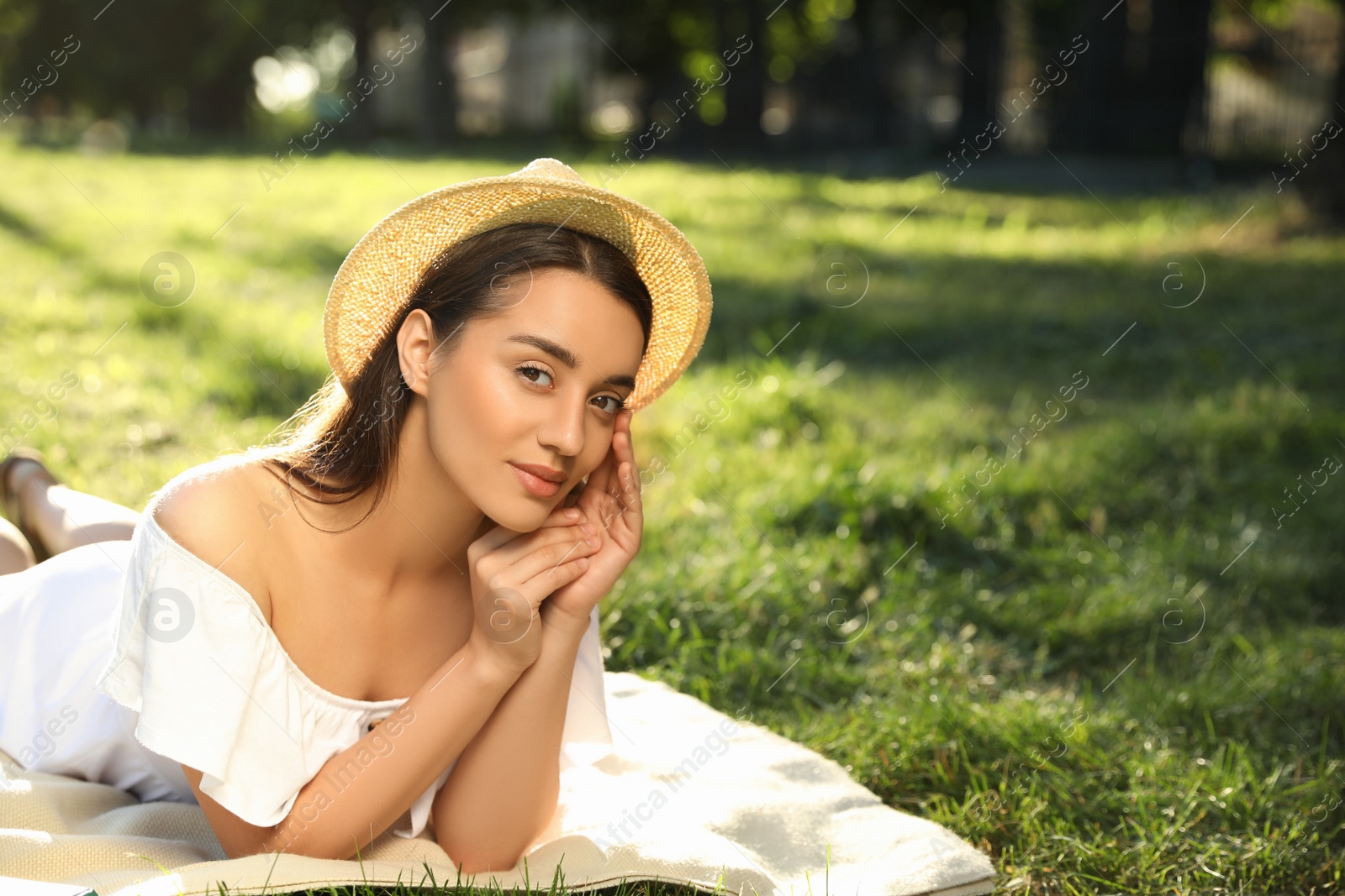 Photo of Beautiful young woman in park on sunny day. Space for text