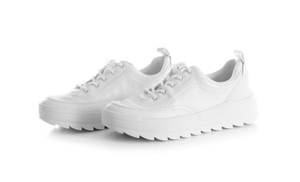 Photo of New stylish sneakers on white background. Trendy footwear