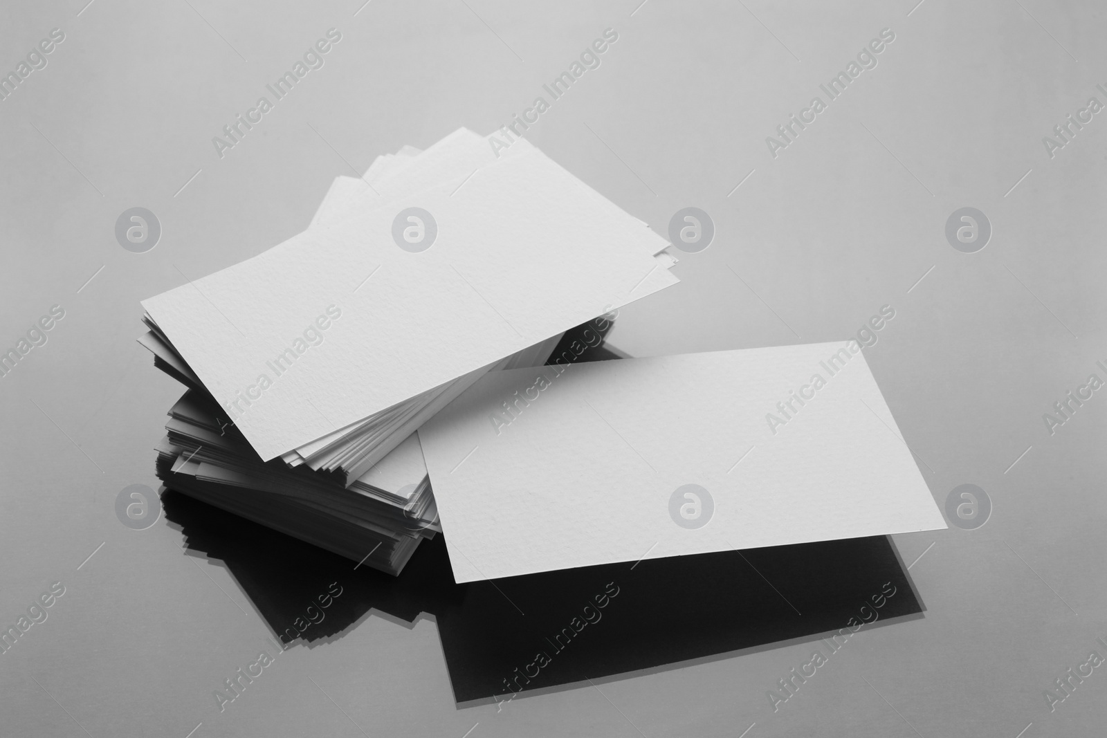 Photo of Blank business cards on mirror surface. Mockup for design