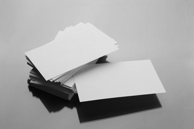 Photo of Blank business cards on mirror surface. Mockup for design
