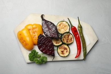 Delicious grilled vegetables on light table, top view