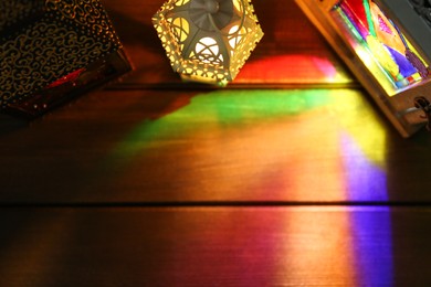 Decorative Arabic lanterns on wooden table, flat lay. Space for text