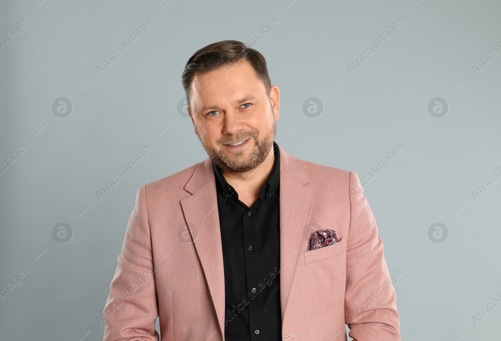 Photo of Portrait of happy mature man on light grey background