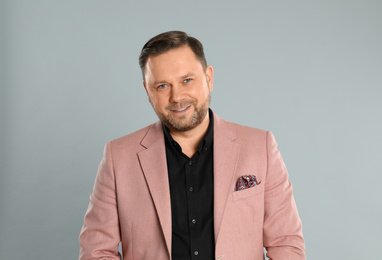 Photo of Portrait of happy mature man on light grey background