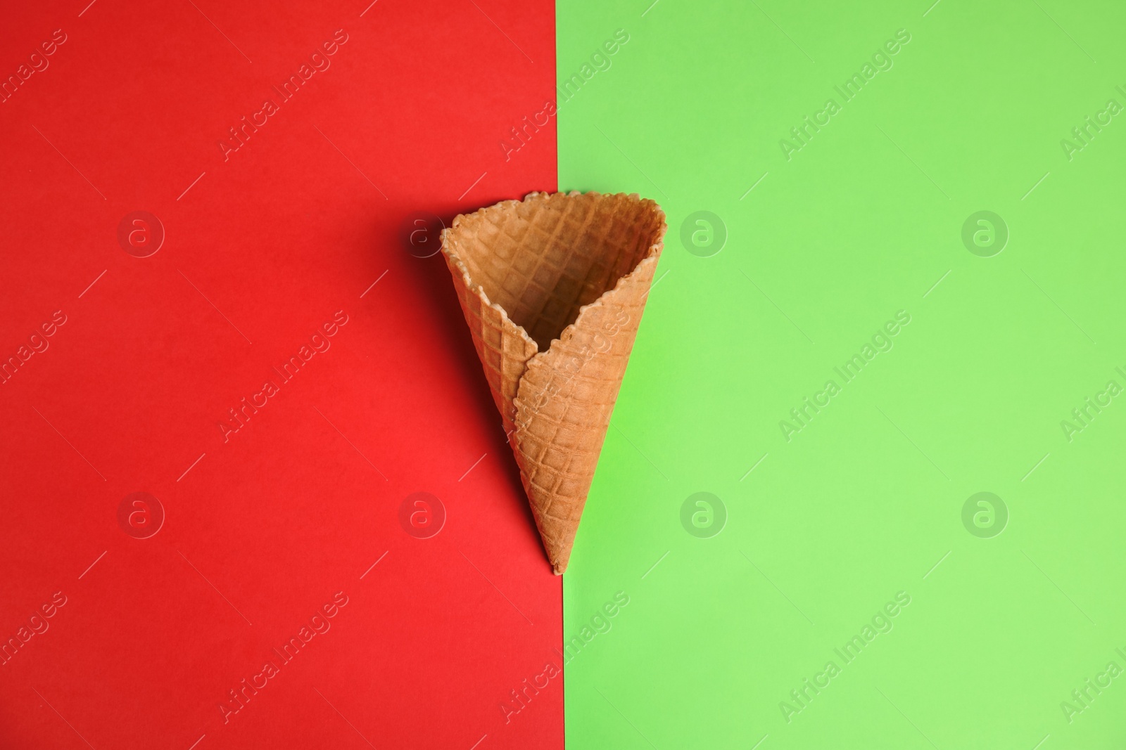 Photo of Waffle empty ice cream cones on color background, flat lay