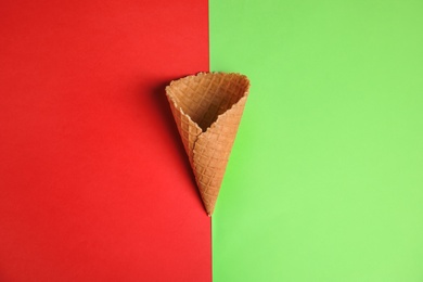 Waffle empty ice cream cones on color background, flat lay