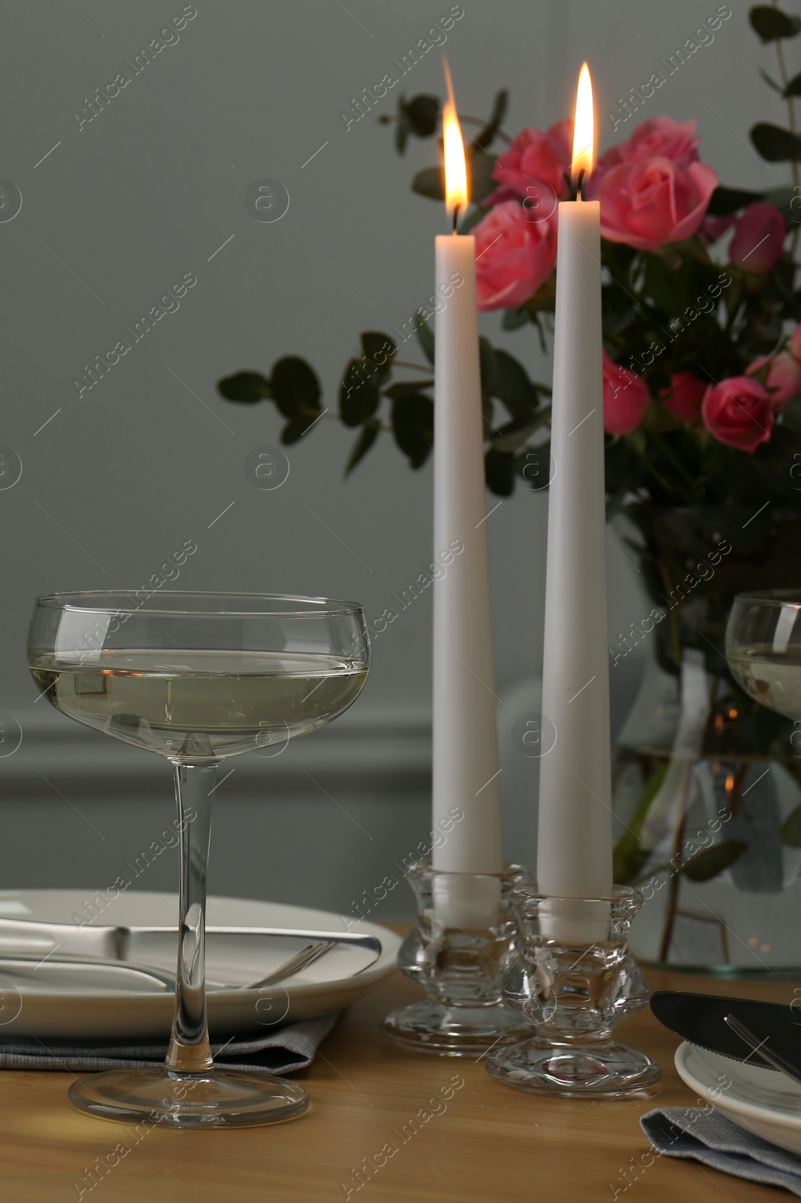 Photo of Romantic table setting with candles and flowers