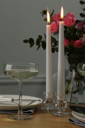 Photo of Romantic table setting with candles and flowers
