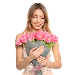 Portrait of smiling young girl with beautiful tulips on white background. International Women's Day